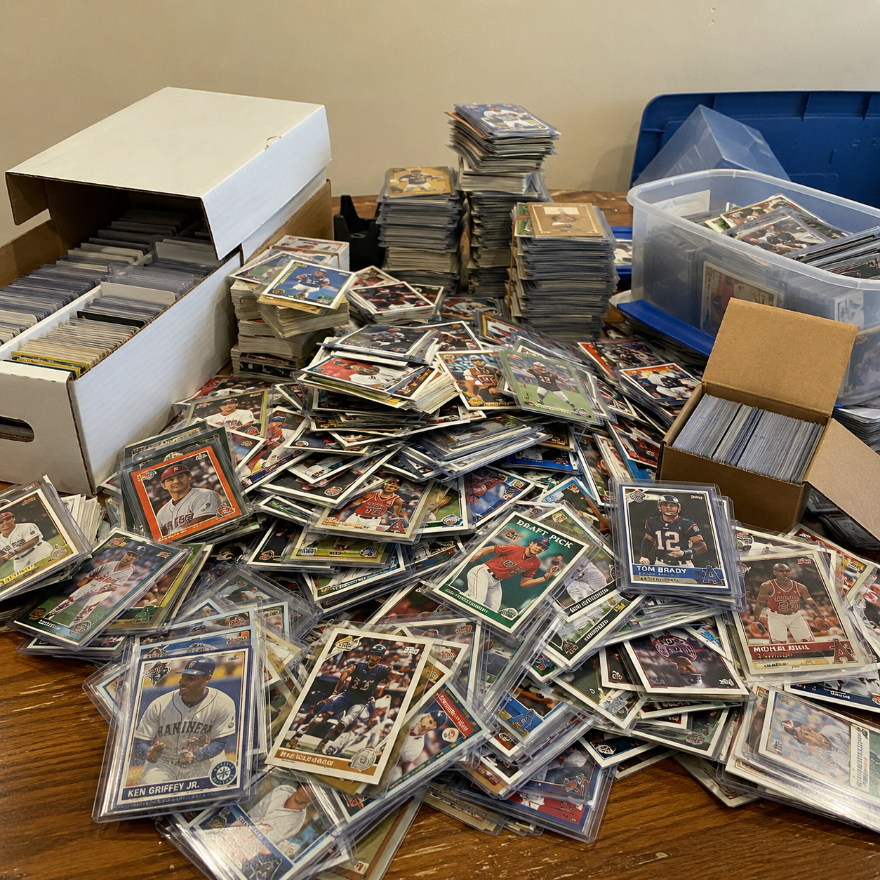 Loose, mixed and unorganized sports cards spilling out of old boxes